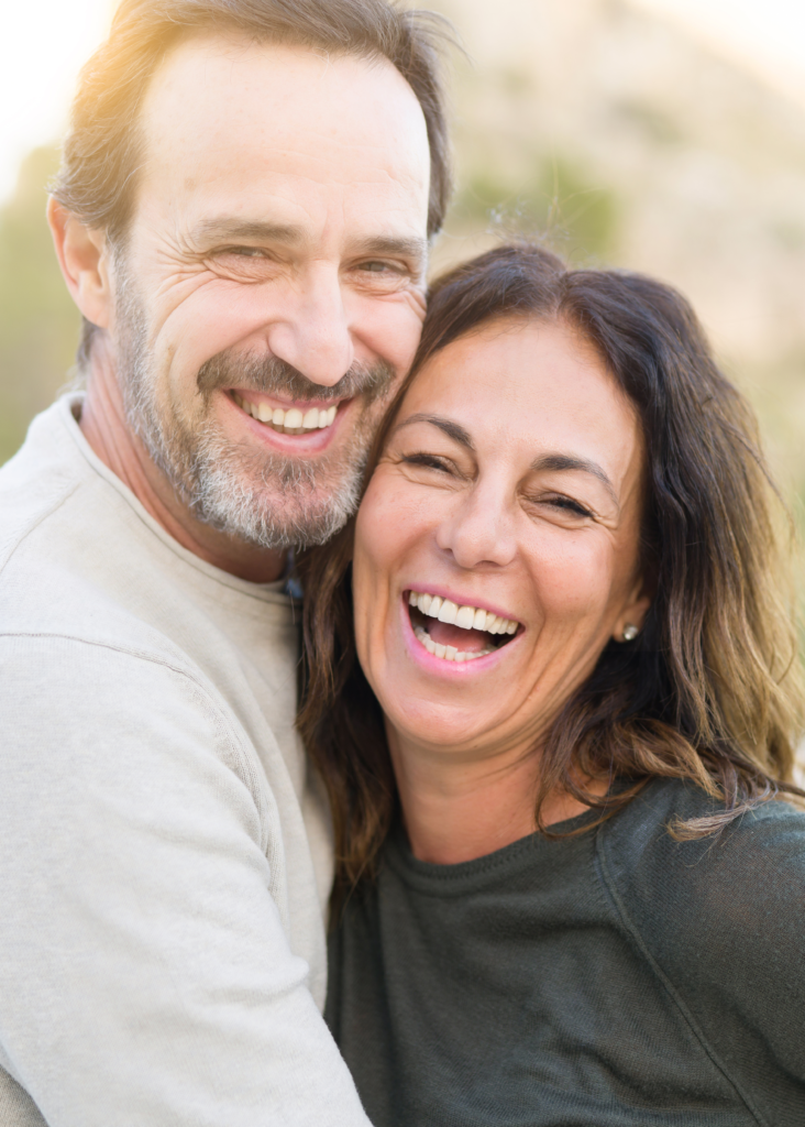 Happy middle-aged couple smiling together, representing vitality and well-being, relevant to Men's Bioidentical Hormone Replacement Therapy at SP Aesthetics.