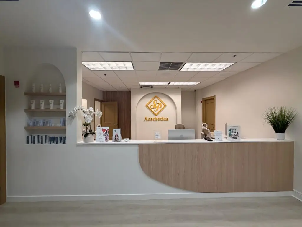 SP Aesthetics modern reception area with front desk, skincare product display, and welcoming clinic interior